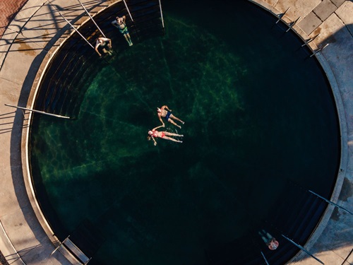 Aerial view of two people soaking in the Lightning Ridge bore Bath